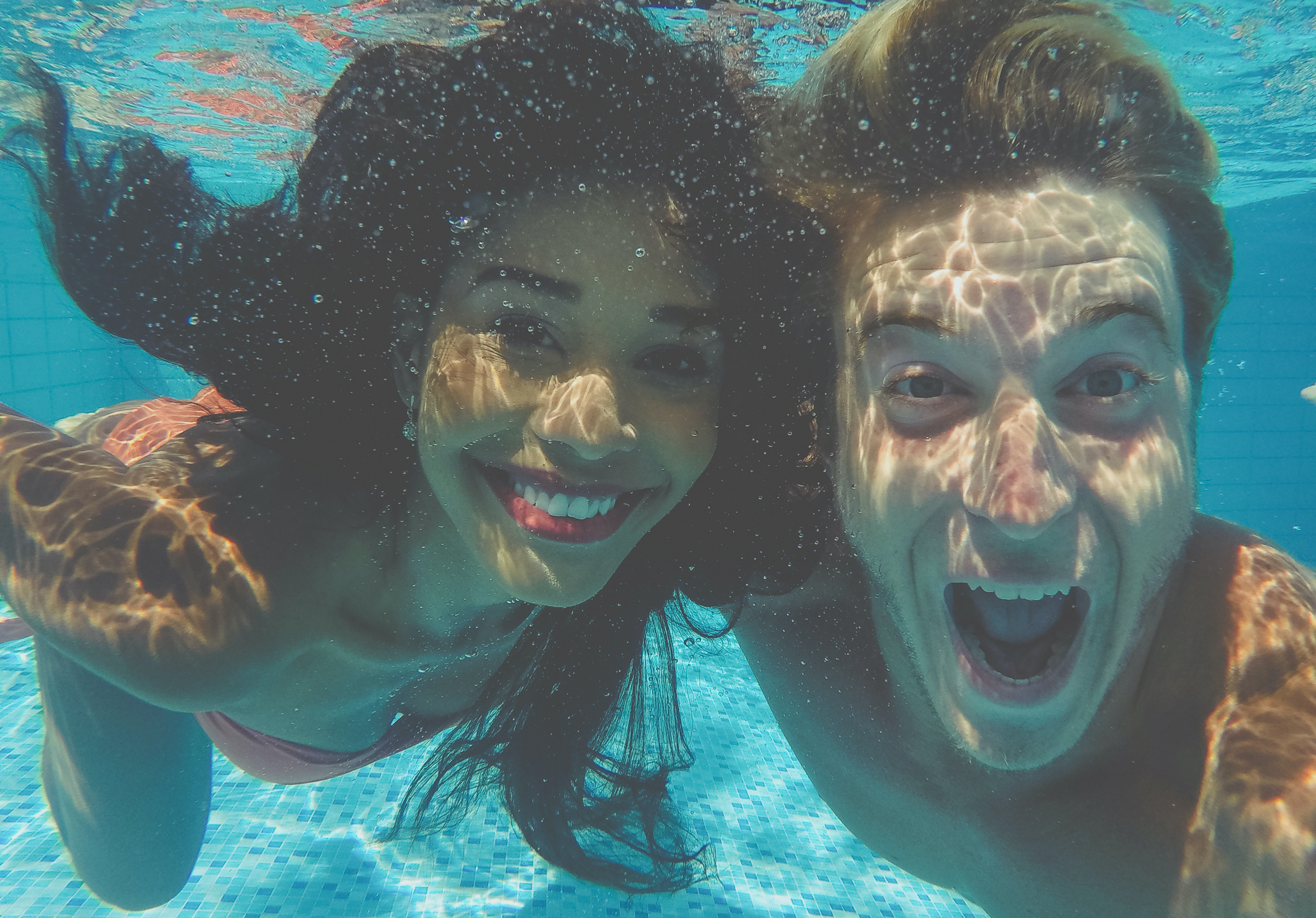 Young couple smiling under water